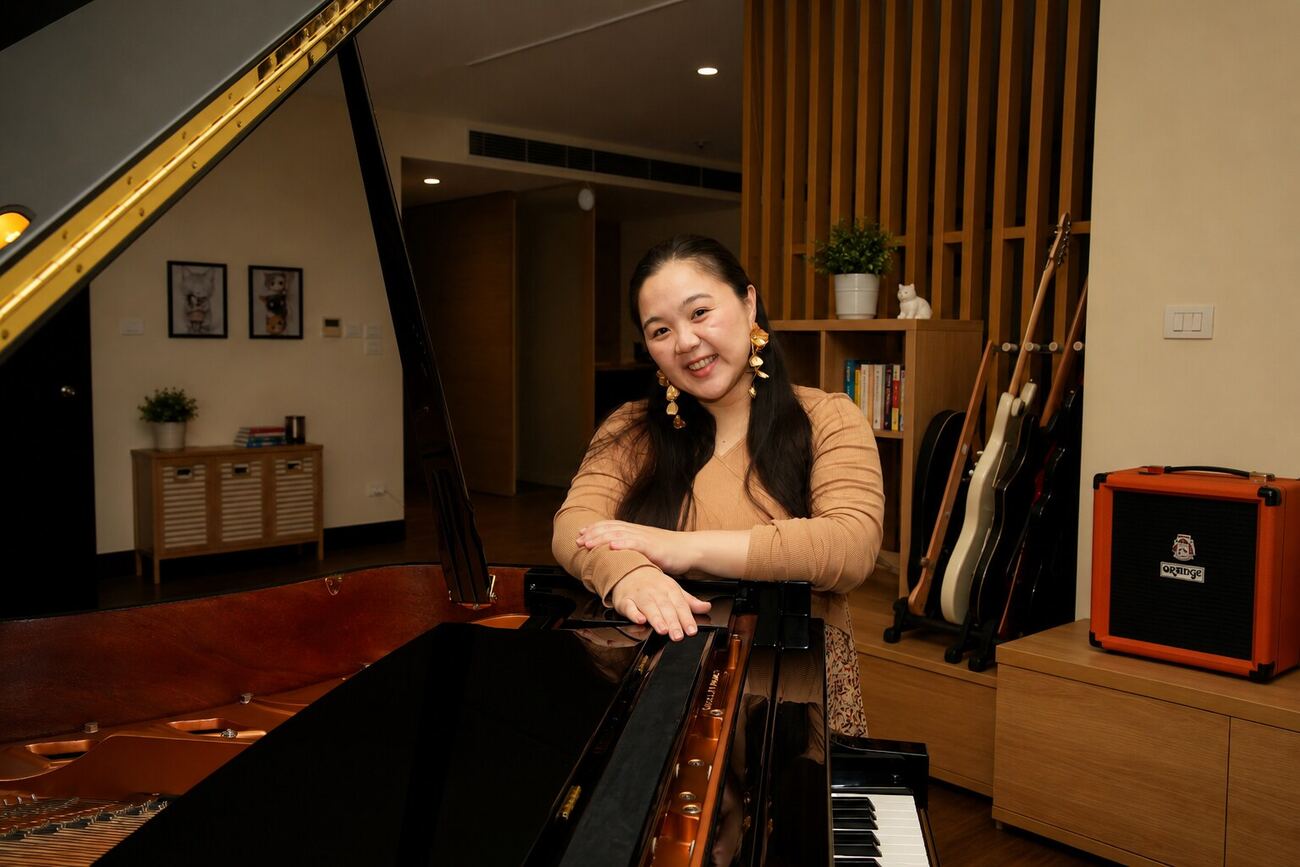 Angel smiling warmly at her grand piano
